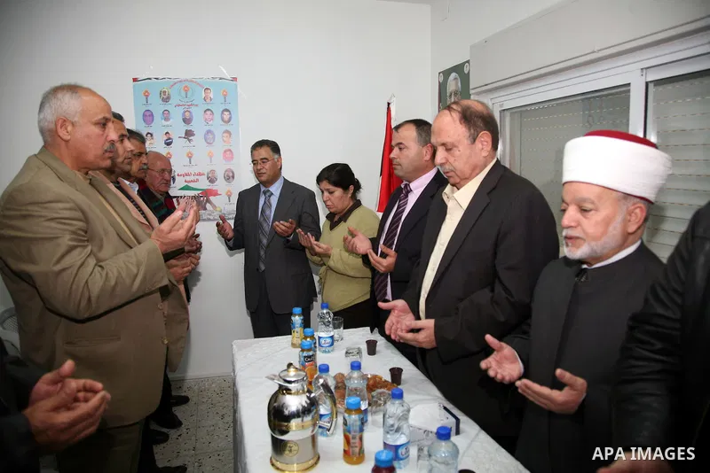 Palestinians attend the opening of the headquarters of the National Alliance for the families of the martyrs in Al-Ram in the West Bank March 27,2011. Sliman Khader