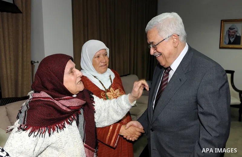 Palestinian President Mahmoud Abbas (Abu Mazen) meets with the Mothers Zakyia Zaid and Farsakha Al deik in west bank city of Ramallah March,28,2011 Photo by Thaer Ganaim