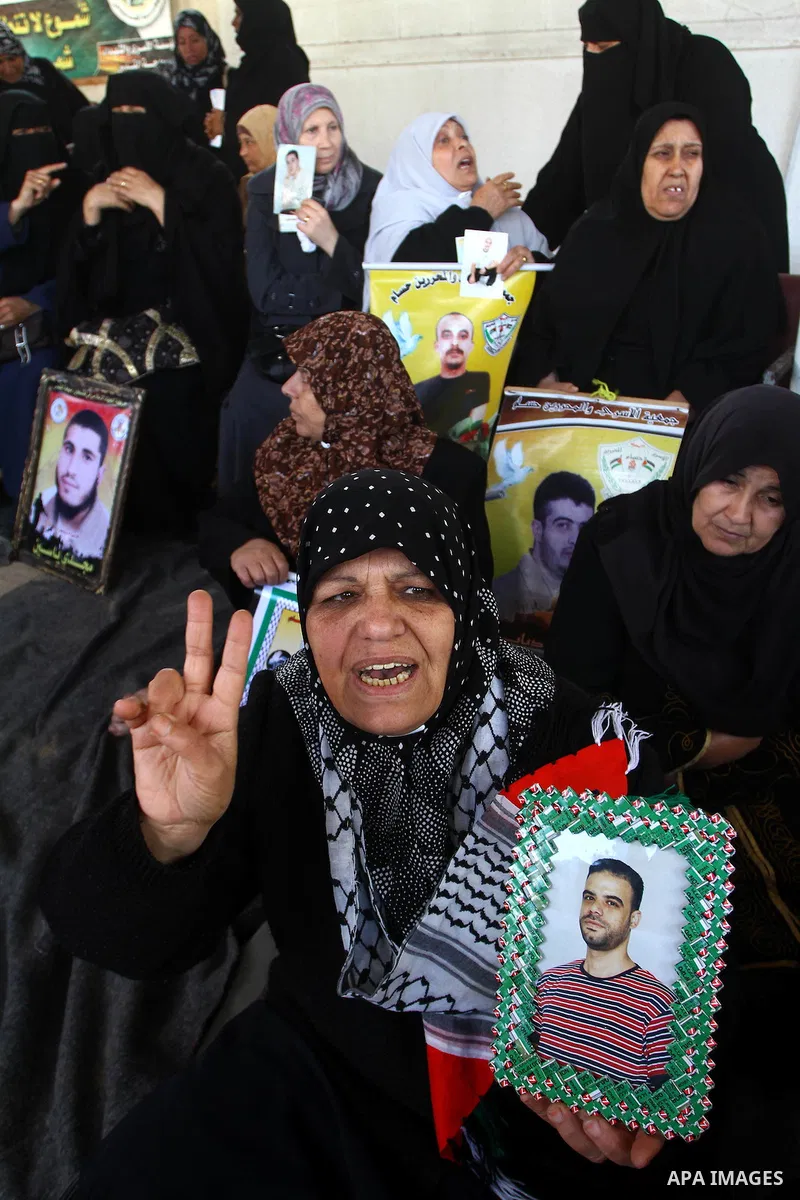 Palestinians women hold pictures of their prisoned relatives in Israeli jails as they gather in a weekly activity calling for their liberty at the Red Cross headquarters in Gaza City on Marsh 28, 2011. About 7000 prisone...
