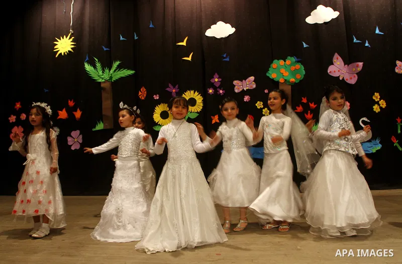 Palestinian children dance during an entertaining celebration organized by UNRWA at Shawwa theatre in Gaza city on March 28,2011.. Photo by Ashraf Amra