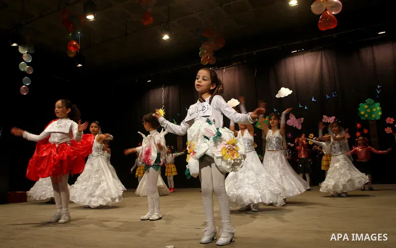Palestinian children dance during an entertaining celebration organized by UNRWA at Shawwa theatre in Gaza city on March 28,2011.. Photo by Ashraf Amra