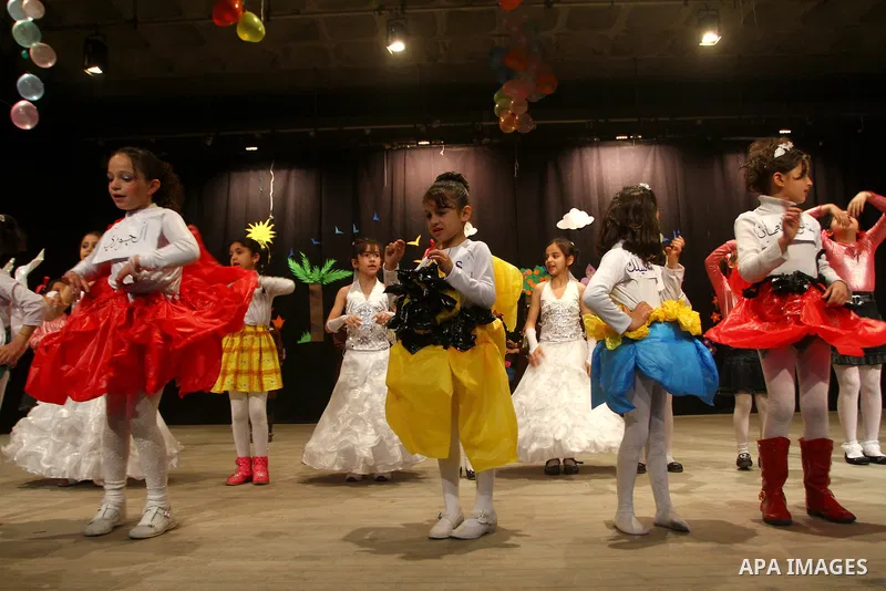 Palestinian children dance during an entertaining celebration organized by UNRWA at Shawwa theatre in Gaza city on March 28,2011.. Photo by Ashraf Amra