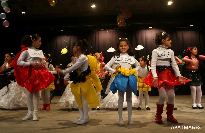 Palestinian children dance during an entertaining celebration organized by UNRWA at Shawwa theatre in Gaza city on March 28,2011.. Photo by Ashraf Amra