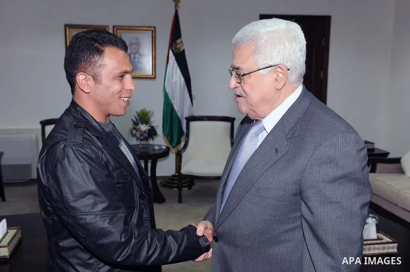 Palestinian President Mahmoud Abbas (Abu Mazen) during a meeting the liberated prisoner, Khalid Abu kamleh in the West Bank city of Ramallah on March 28, 2011. Photo by Thaer Ganaim