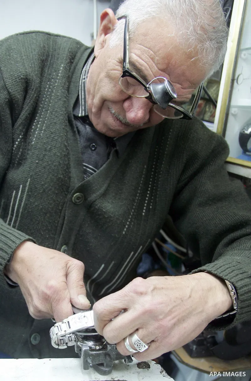 A Palestinian watches fixer repairs a watch at his shop in the market of the old city of Jerusalem on March 28,2011. Photo by Mahfouz Abu Turk