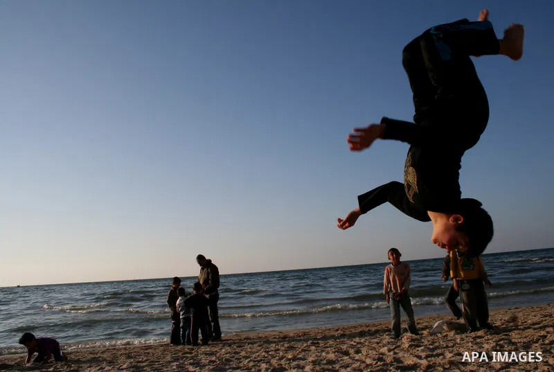 Palestinian youths practice jumping on the beach in Gaza City, on March 28, 2011 as they enjoy their free time. Photo by Mahmoud Nassar