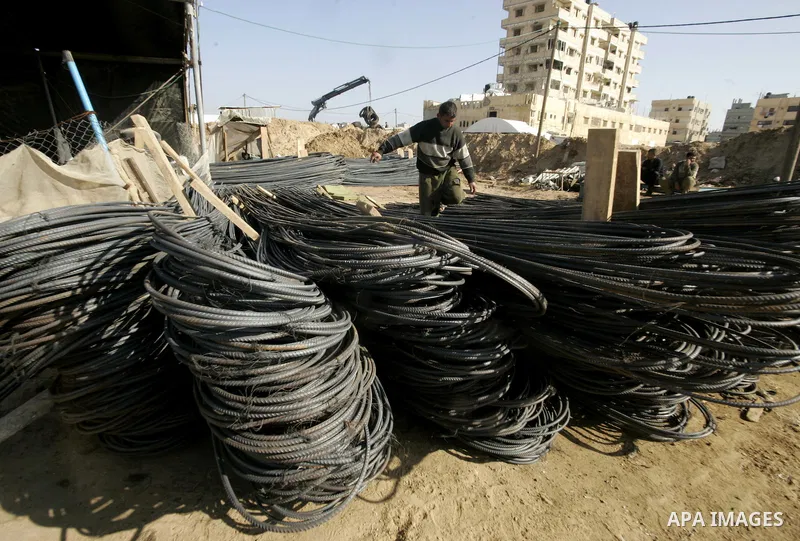 Palestinian man assembles iron coming from a tunnel used for smuggling goods into the Gaza Strip, which links Egypt to the southern Gaza town of Rafah, on March 29, 2011. Underground tunnels located on the frontier betwe...