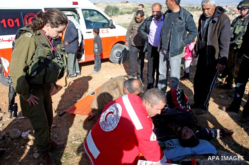 Palestinian medics treat a woman after her home was destroyed allegedly by Israeli army tractors early on 29 March 2011 in the West Bank village of Yatta near Hebron. The house was located in the so-called Area C, a clos...