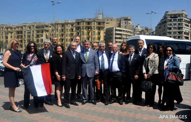 Tourists take memorial photos on March 29,2011 at the downtown Cairo's Tahrir square, the giant traffic-clogged roundabout, which hundreds of thousands of Egyptians turned into the focus of their uprising to bring down H...