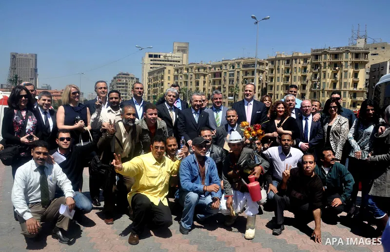 Tourists take memorial photos on March 29,2011 at the downtown Cairo's Tahrir square, the giant traffic-clogged roundabout, which hundreds of thousands of Egyptians turned into the focus of their uprising to bring down H...