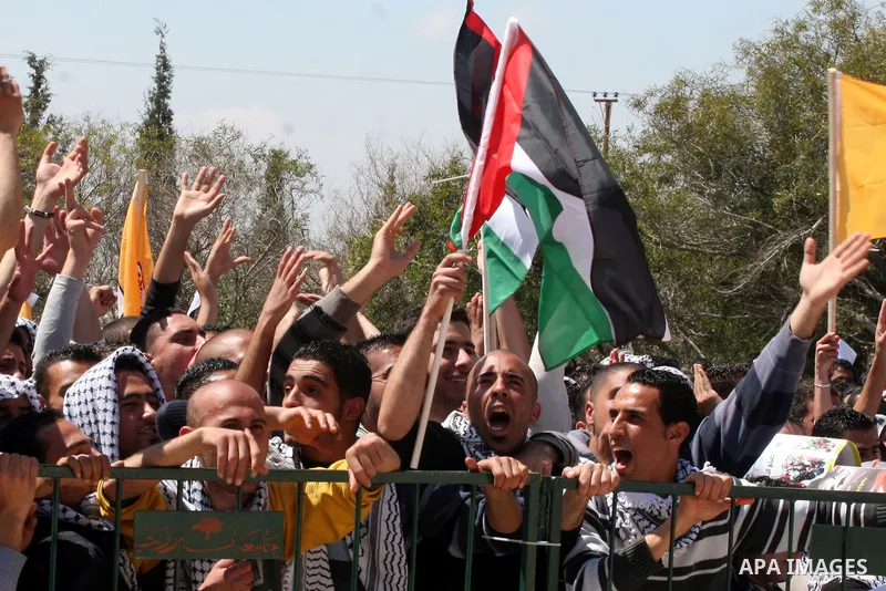 Palestinian students and Fatah supporters who loyal to the Palestinian President Mahmoud Abbas take part in Birzeit University Student Council elections campaign at the Birzeit University, in the West Bank city of Ramall...
