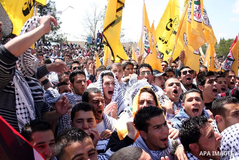 Palestinian students and Fatah supporters who loyal to the Palestinian President Mahmoud Abbas take part in Birzeit University Student Council elections campaign at the Birzeit University, in the West Bank city of Ramall...