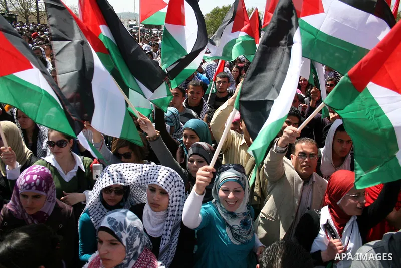 Palestinian students and Fatah supporters who loyal to the Palestinian President Mahmoud Abbas take part in Birzeit University Student Council elections campaign at the Birzeit University, in the West Bank city of Ramall...
