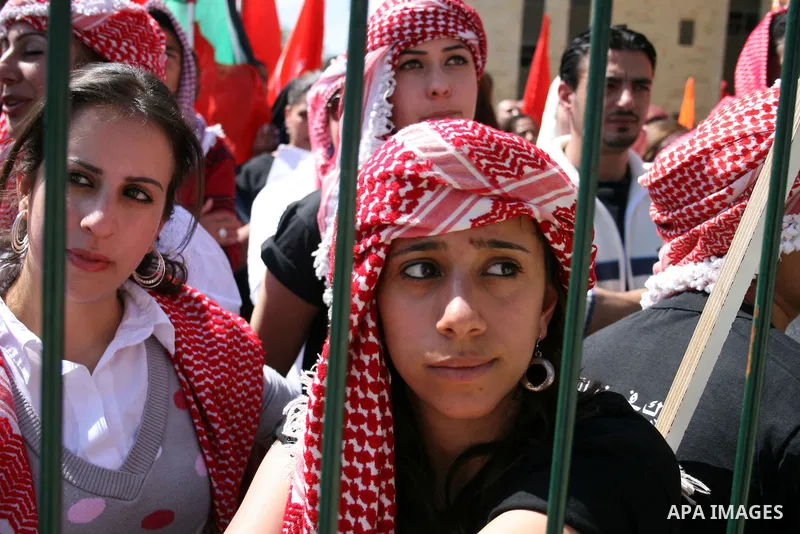 Palestinian students and Fatah supporters who loyal to the Palestinian President Mahmoud Abbas take part in Birzeit University Student Council elections campaign at the Birzeit University, in the West Bank city of Ramall...