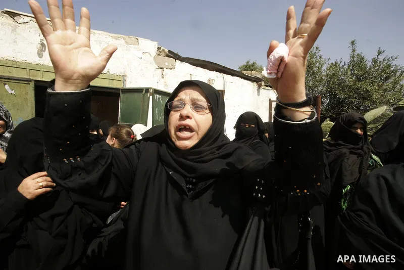 Palestinian women mourn during the funeral of Mohammed Muammar, who was killed during an Israeli air strike the previous day, in Khan Yunis, southern Gaza Strip, on March 30, 2011. The raid killed Muammar and wounded the...
