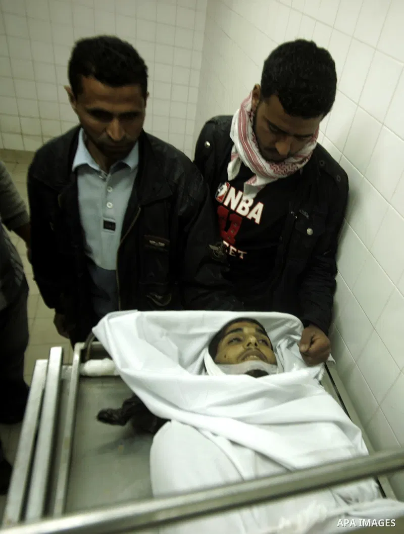 Palestinian relatives mourn over the body of Mohammed Muammar in the mourge, who was killed during an Israeli air strike the previous day, southern Gaza Strip, on March 30, 2011. The raid killed Muammar and wounded the o...