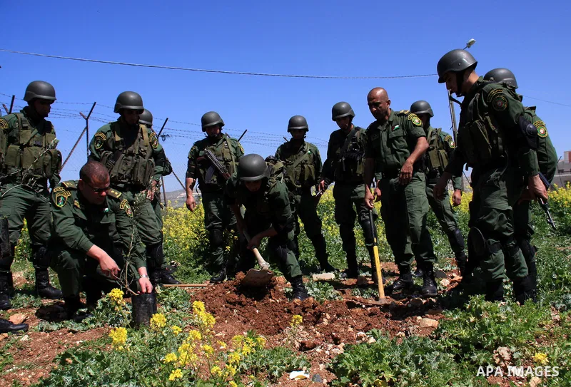 Palestinian security officers plant trees during an event marking Land Day, near the West Bank city of Nablus, Wednesday, March 30, 2011. Land Day commemorates the killing of six Arab citizens of Israel by the Israelis o...