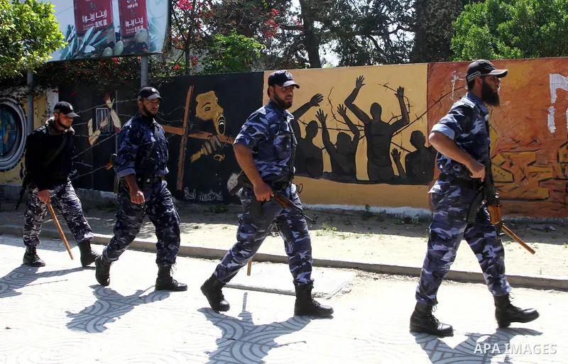 Palestinian Hamas security patrol in a street as Palestinian demonstrators take part in a protest calling for political unity between Gaza's Hamas rulers and the Fatah-dominated Palestinian Authority based in the West Ba...