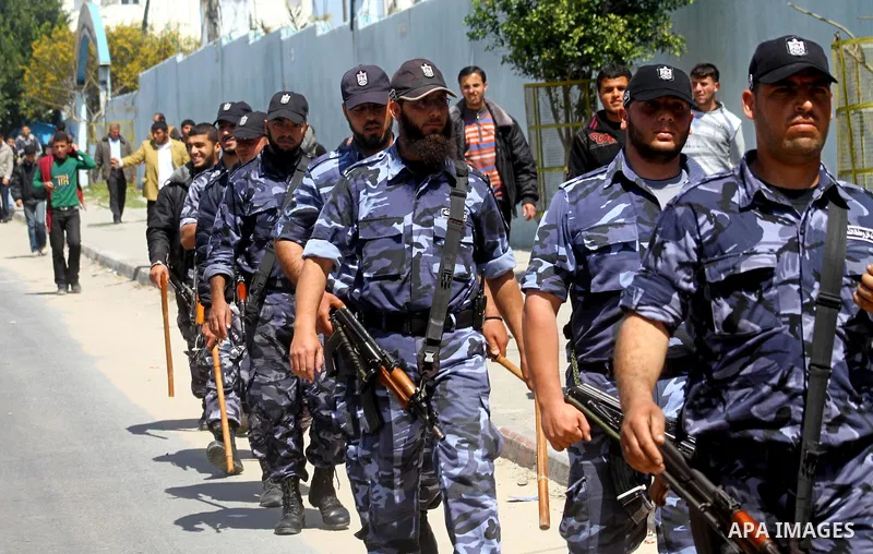Palestinian Hamas security patrol in a street as Palestinian demonstrators take part in a protest calling for political unity between Gaza's Hamas rulers and the Fatah-dominated Palestinian Authority based in the West Ba...