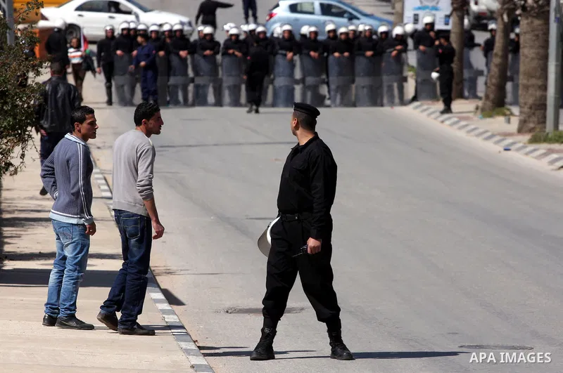 Palestinians anti-riot Police block the road to prevent Palestinian protesters, marking the 35th anniversary of the Land Day, to reach the Israeli checkpoint of Biet El north of Ramallah, 30 March 2011. The rallies kicke...