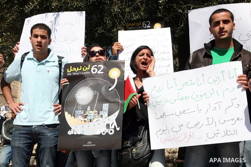 Palestinians take part in a demonstration at the Damascus Gate in East Jerusalem on Mar 30,2011, as hundreds of people across Israel and Palestinian territories were holding a series of rallies marking "Land Day," recall...