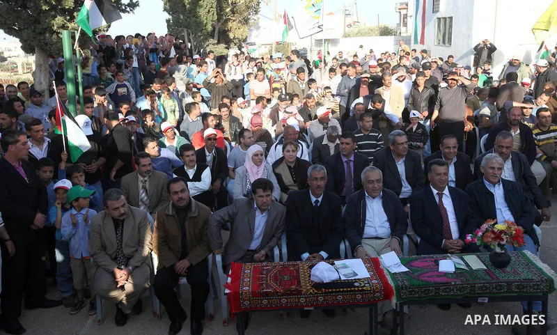 Palestinian prime minister Salam Fayyad plants olive trees in al-Magher village near Ramallah in the occupied West Bank, on March 30, 2011, as hundreds of people across Israel and Palestinian territories were holding a s...