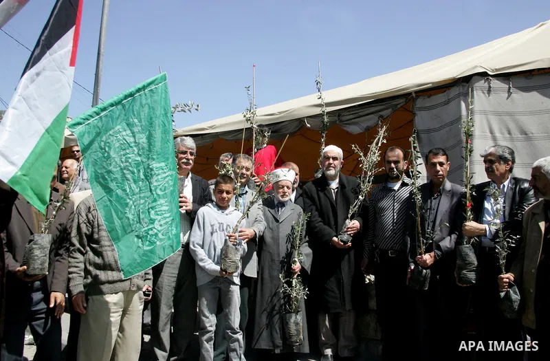 Sheikh Raed Salah and other Palestinians plant olive trees at the Mount of Olives, in East Jerusalem to mark the Land Day on March 30,2011, as hundreds of people across Israel and Palestinian territories were holding a s...
