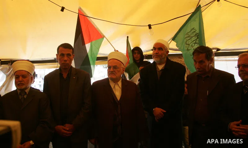 Sheikh Raed Salah and other Palestinians plant olive trees at the Mount of Olives, in East Jerusalem to mark the Land Day on March 30,2011, as hundreds of people across Israel and Palestinian territories were holding a s...