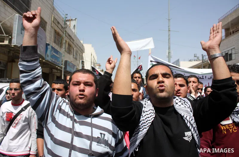 Palestinian protesters take part in a march in solidarity with Palestinian prisoners in Israeli jails and calling for end the split between the two rival leading Palestinian factions Fatah and Hamas, in the West Bank cit...