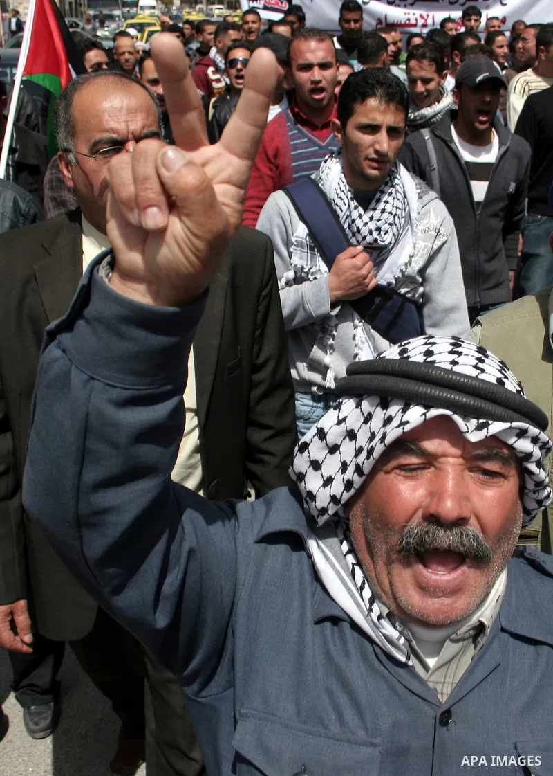 Palestinian protesters take part in a march in solidarity with Palestinian prisoners in Israeli jails and calling for end the split between the two rival leading Palestinian factions Fatah and Hamas, in the West Bank cit...