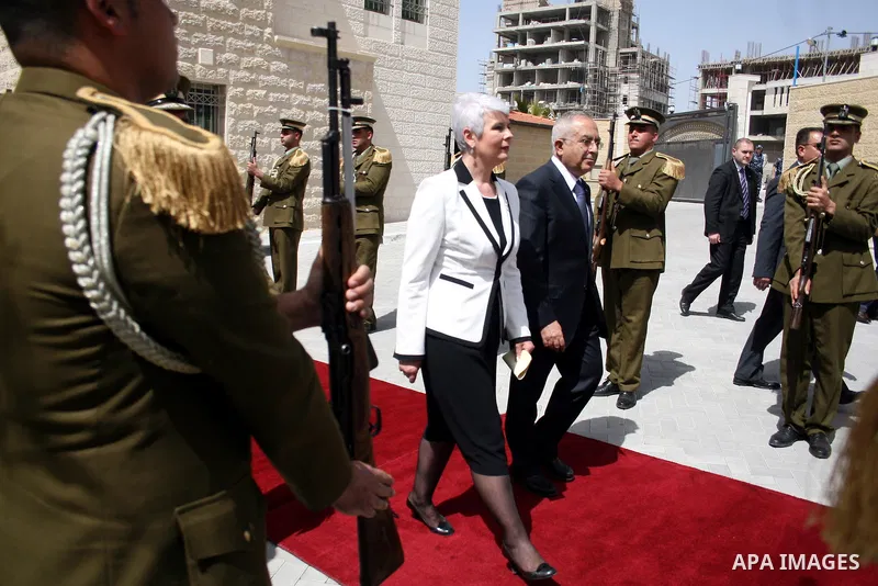 Palestinian Prime Minister Salam Fayyad reviews honor guards with the Croatian counterpart Jadranka Kosor upon her arrival to the West Bank city of Ramallah, on March 31,2011. Photo by Issam Rimawi
