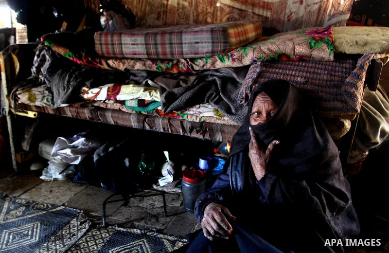 A Palestinian woman sits at her miserable tent in one of the most poor regions in the Gaza Strip on March,31, 2011. Photo by Ashraf Amra