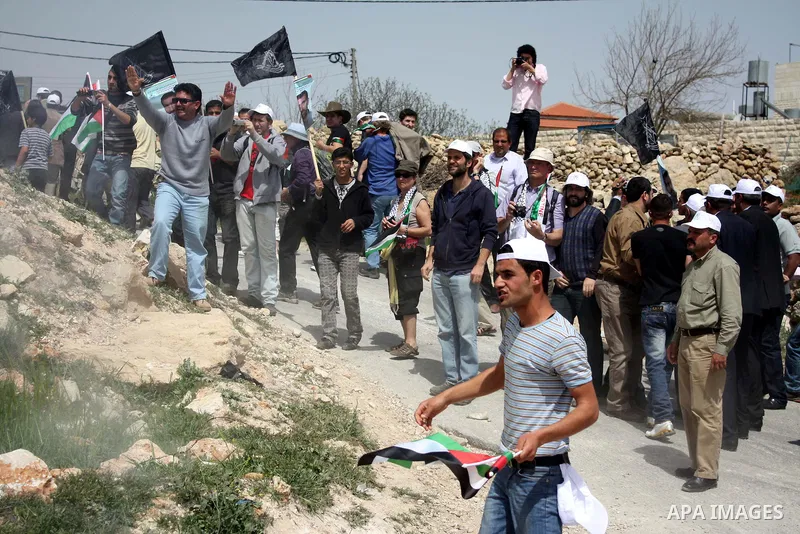 Israeli soldiers fire tear gas canisters towards demonstrators during a protest against Israel's controversial separation barrier and to mark "Land Day" in the West Bank village of Maasarah, near the biblical town of Bet...