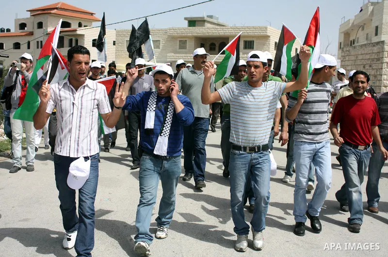 Israeli soldiers scuffle with demonstrators during a protest against Israel's controversial separation barrier and to mark "Land Day" in the West Bank village of Maasarah, near the biblical town of Bethlehem, on April 01...