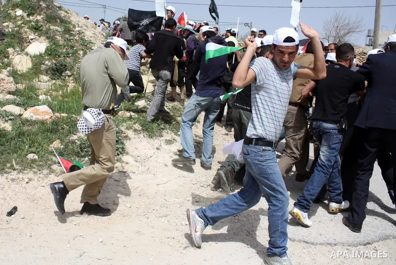 Israeli soldiers fire tear gas canisters towards demonstrators during a protest against Israel's controversial separation barrier and to mark "Land Day" in the West Bank village of Maasarah, near the biblical town of Bet...