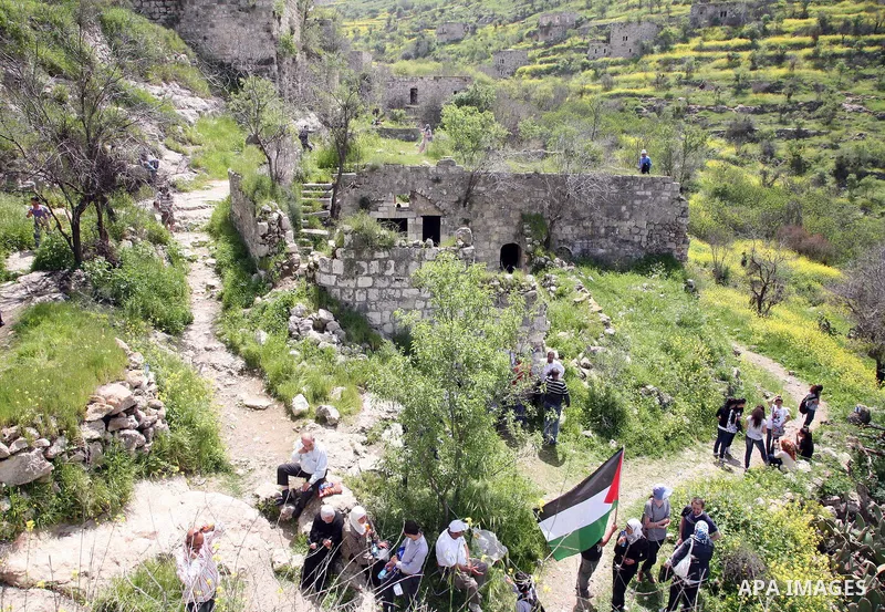 Palestinian Muslims gather around the remains of an old mosque in the village of Lifta, which have been displaced from her owners in 1948 on April 1,2011. Photo by Sliman Khader.