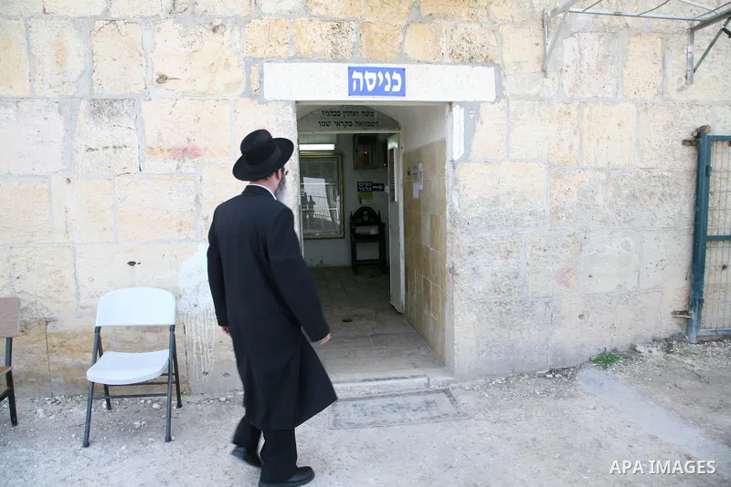 An Orthodox Jewish walks outside a part of a mosque in the Village of the Prophet Samuel, which has been converted into a Jewish synagogue on April 1,2011. Photo by Sliman Khader.