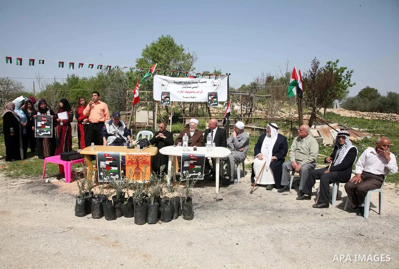 Sheikh Raed Salah and other Palestinians plant olive trees in the Village of the Prophet Samuel, near Jerusalem on April 1,2011. Photo by Sliman Khader.