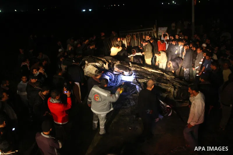 Members of Hamas' security forces inspect a car after an Israeli air strike in Deir Al-Balah in the central Gaza Strip early April 2, 2011. Israeli aircraft killed three Palestinian gunmen in the southern Gaza Strip earl...