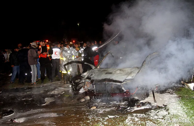 Members of civil defence try to stop fire in a car after an Israeli air strike in Deir Al-Balah in the central Gaza Strip early April 2 2011. Israeli aircraft killed three Palestinian gunmen in the southern Gaza Strip ....