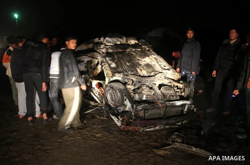 Palestinian Hamas officers inspect a vehicle following an Israeli airstrike that killed three of Hamas militants near Deir Al Balah, central Gaza Strip, early Saturday, April 2, 2011. Israeli aircraft killed the militant...