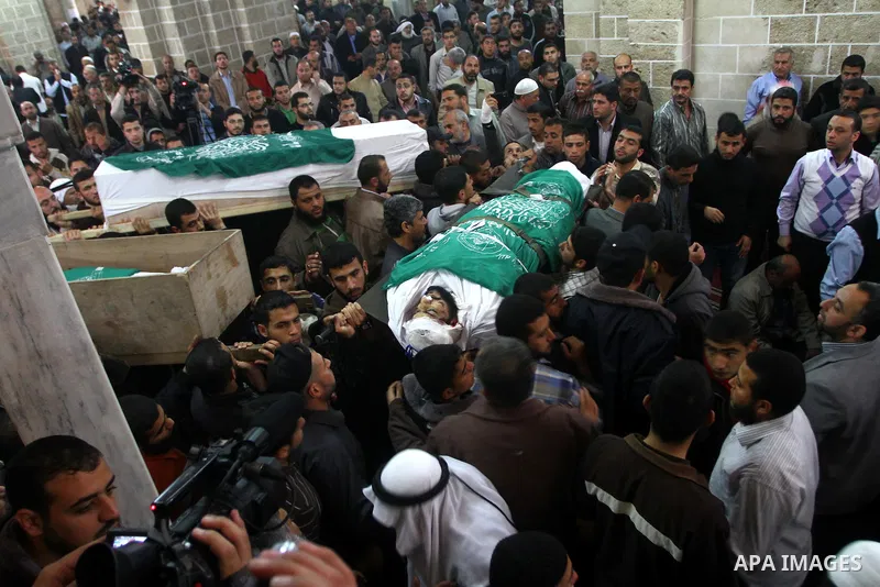 Palestinians carry the bodies of Hamas militants in Al-Omari Mosque during their funeral in Gaza City April 2, 2011. Israeli aircraft killed three Palestinian gunmen in the southern Gaza Strip early on Saturday, medical...
