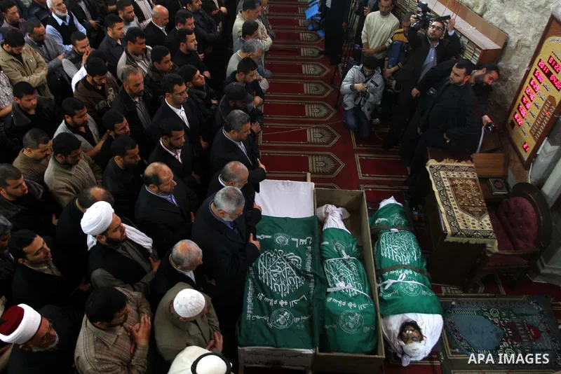 Palestinians pray next to the bodies of Hamas militants in Al-Omari Mosque during their funeral in Gaza City April 2, 2011. Israeli aircraft killed three Palestinian gunmen in the southern Gaza Strip early on Saturday, m...