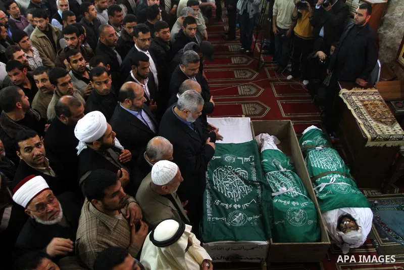 Palestinians pray next to the bodies of Hamas militants in Al-Omari Mosque during their funeral in Gaza City April 2, 2011. Israeli aircraft killed three Palestinian gunmen in the southern Gaza Strip early on Saturday, m...