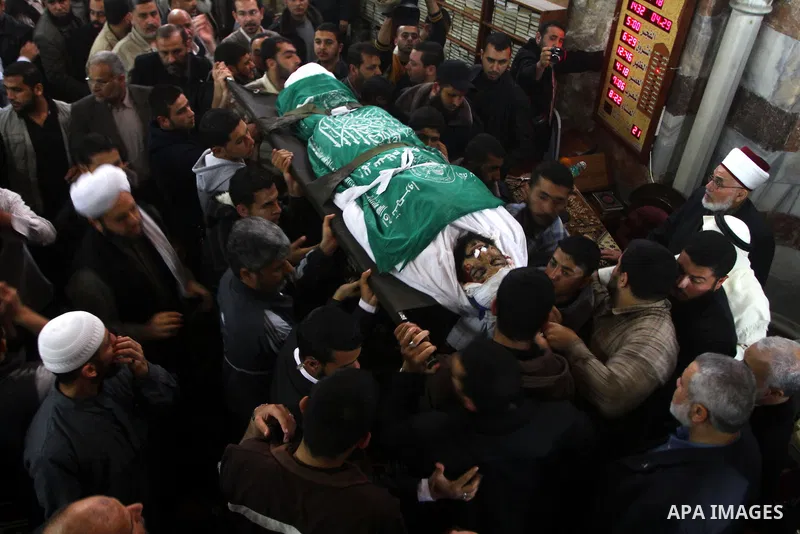 Palestinians carry the bodies of Hamas militants in Al-Omari Mosque during their funeral in Gaza City April 2, 2011. Israeli aircraft killed three Palestinian gunmen in the southern Gaza Strip early on Saturday, medical...