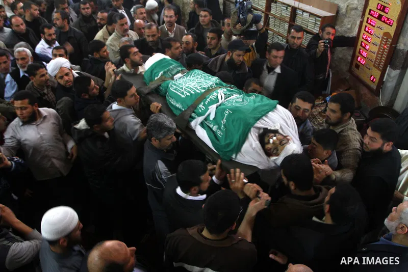Palestinians carry the bodies of Hamas militants in Al-Omari Mosque during their funeral in Gaza City April 2, 2011. Israeli aircraft killed three Palestinian gunmen in the southern Gaza Strip early on Saturday, medical...