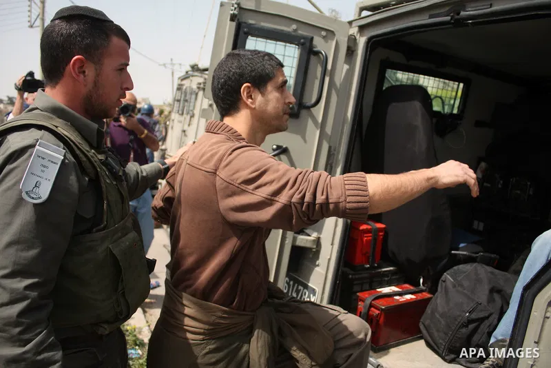 Israeli soldiers detain a demonstrator during a protest by foreign, Israeli and Palestinian demonstrators against the controversial Israeli separation barrier, in the Palestinian village of Beit Omar, near the West Bank...