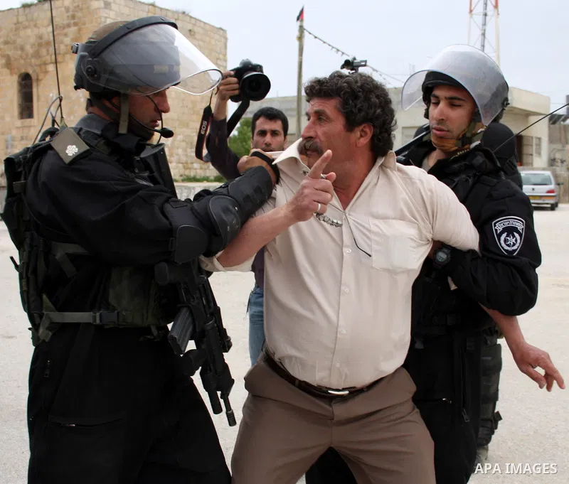 Israeli soldiers detain a Palestinian youth who they said was throwing stones during a demonstration against the expansion of the nearby Jewish settlement of Halamish in the West Bank village of Nabi Saleh near Ramallah,...