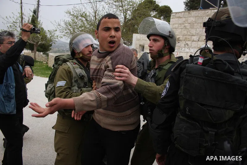Israeli soldiers detain a Palestinian youth who they said was throwing stones during a demonstration against the expansion of the nearby Jewish settlement of Halamish in the West Bank village of Nabi Saleh near Ramallah,...