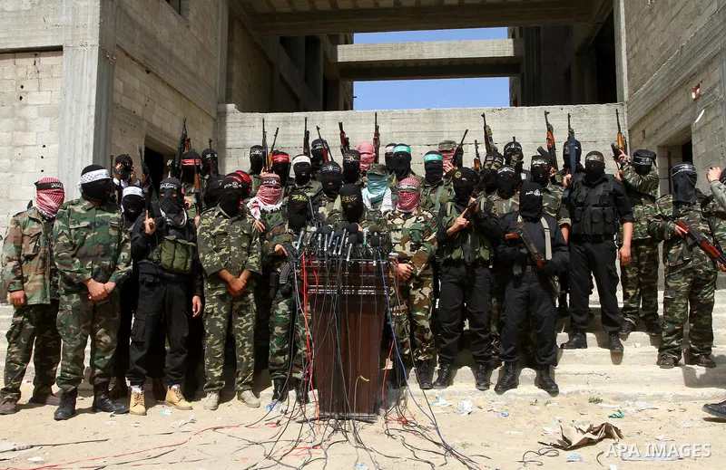 Masked Palestinian militants from various groups, including the Islamic Hamas movement, attend a press conference in Gaza City, Sunday, April 3, 2011. Israel warned its citizens in Egypt's Sinai Peninsula to evacuate imm...